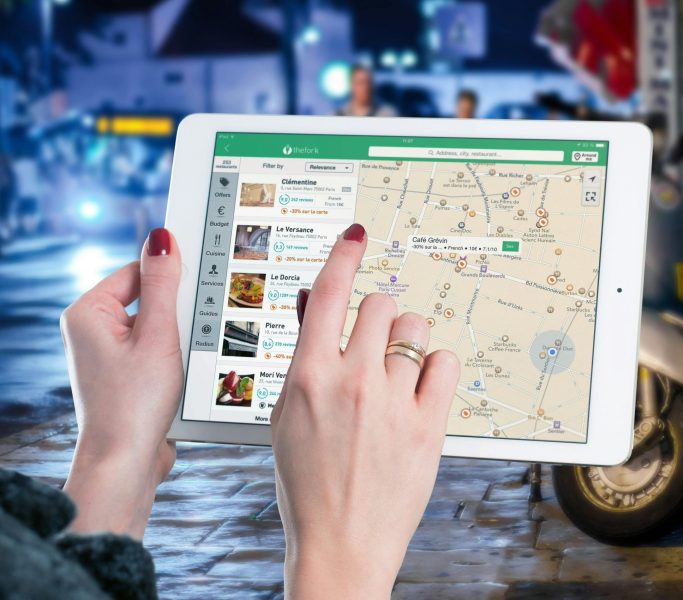 ipad map tablet internet 38271 38271 2 Hands using a digital map on a tablet in an urban setting at night, illustrating navigation and technology.